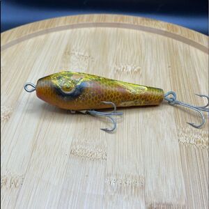Fishing lure with melted rubber skirting on it